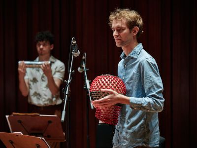 Students playing percussion instruments on stage